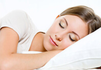 Woman sleeping on a white pillow.